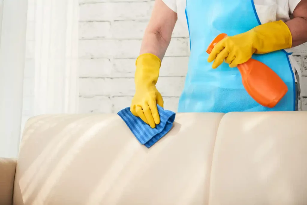 man cleaning sofa